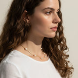 gold pearl station necklace, pearl chain necklace, freshwater pearl necklace, dainty pearl necklace on model, gold and pearl jewelry, scattered pearl necklace, layering pearl necklace, delicate pearl chain