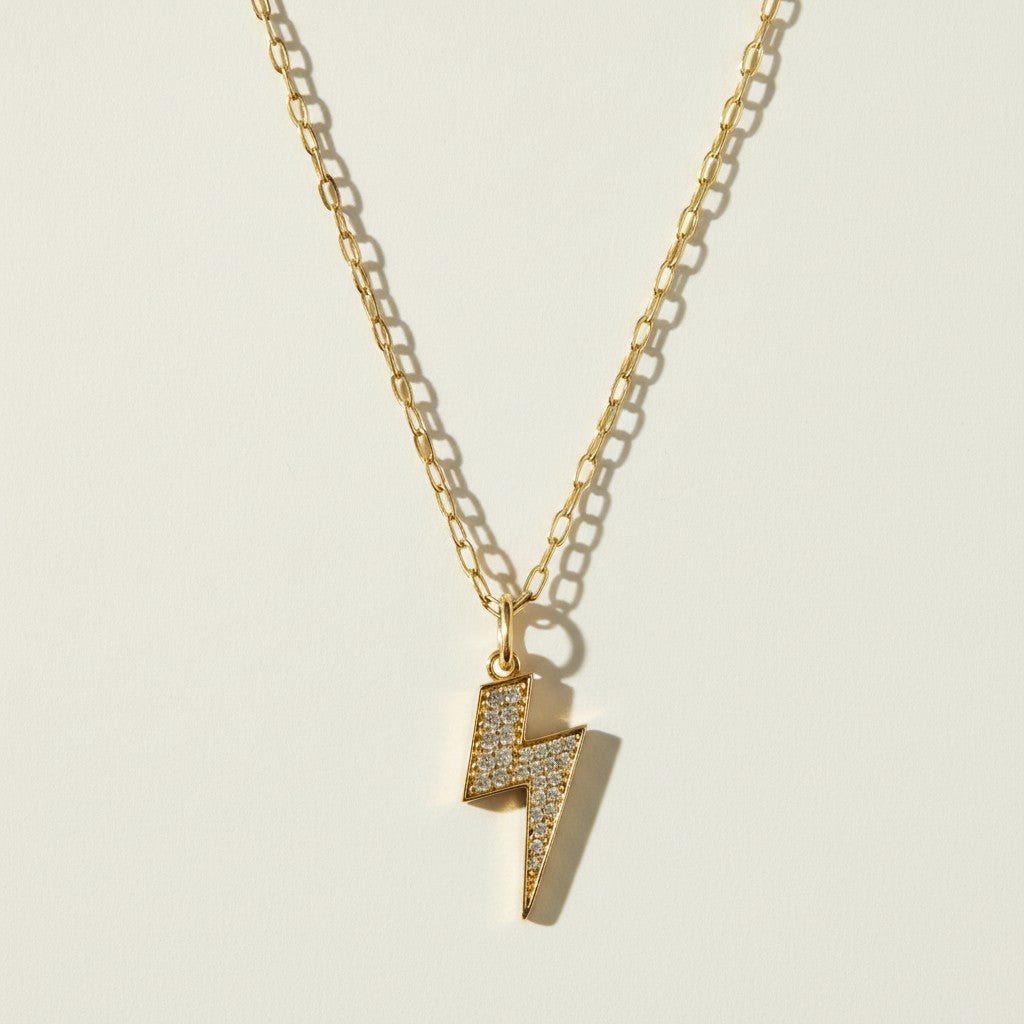 lightning bolt necklace, pave crystal pendant, gold lightning bolt charm, figaro chain necklace, statement pendant necklace, crystal bolt necklace, edgy gold jewelry, lightning pendant on-model