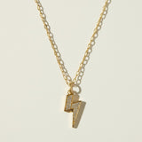 lightning bolt necklace, pave crystal pendant, gold lightning bolt charm, figaro chain necklace, statement pendant necklace, crystal bolt necklace, edgy gold jewelry, lightning pendant on-model