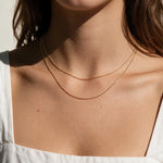 layered gold ball chain necklace, dainty bead chain necklace on model, faceted gold chain, thin gold layering necklaces, two layer gold necklace, minimalist gold necklace, delicate gold chain, collarbone necklace, everyday gold necklace, sparkly gold bead chain, women’s layering necklace, summer gold necklace