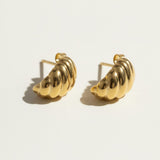 ribbed gold hoop earrings flat lay, fluted gold dome earrings detail, croissant hoop earrings, sculptural ribbed earrings, high polish gold hoops, textured gold stud earrings, retro gold earrings, gold dome earring construction