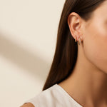 pavé huggie hoop earrings, gold huggie earrings on model, stacked hoop earrings, small pavé hoop earrings, everyday gold hoops, ear stack earrings, sparkle huggie hoops, minimalist gold hoops
