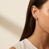 pavé huggie hoop earrings, gold huggie earrings on model, stacked hoop earrings, small pavé hoop earrings, everyday gold hoops, ear stack earrings, sparkle huggie hoops, minimalist gold hoops