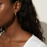 chunky round hoop earrings, gold tube hoop earrings, bold gold hoops on model, small chunky hoops, polished round hoops, statement gold hoops, everyday hoop earrings, thick gold hoop earrings