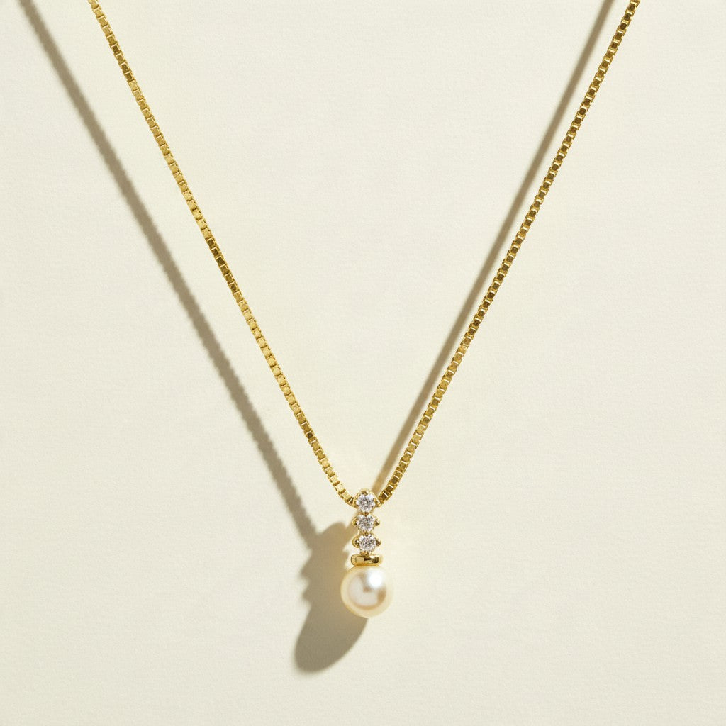 pearl pendant necklace, pearl drop necklace, gold box chain necklace, pearl and crystal necklace, dainty pearl necklace, bridal pearl necklace, classic pearl pendant, gold chain pearl necklace, cubic zirconia pearl pendant, elegant pearl necklace, wedding necklace, women’s pearl pendant necklace