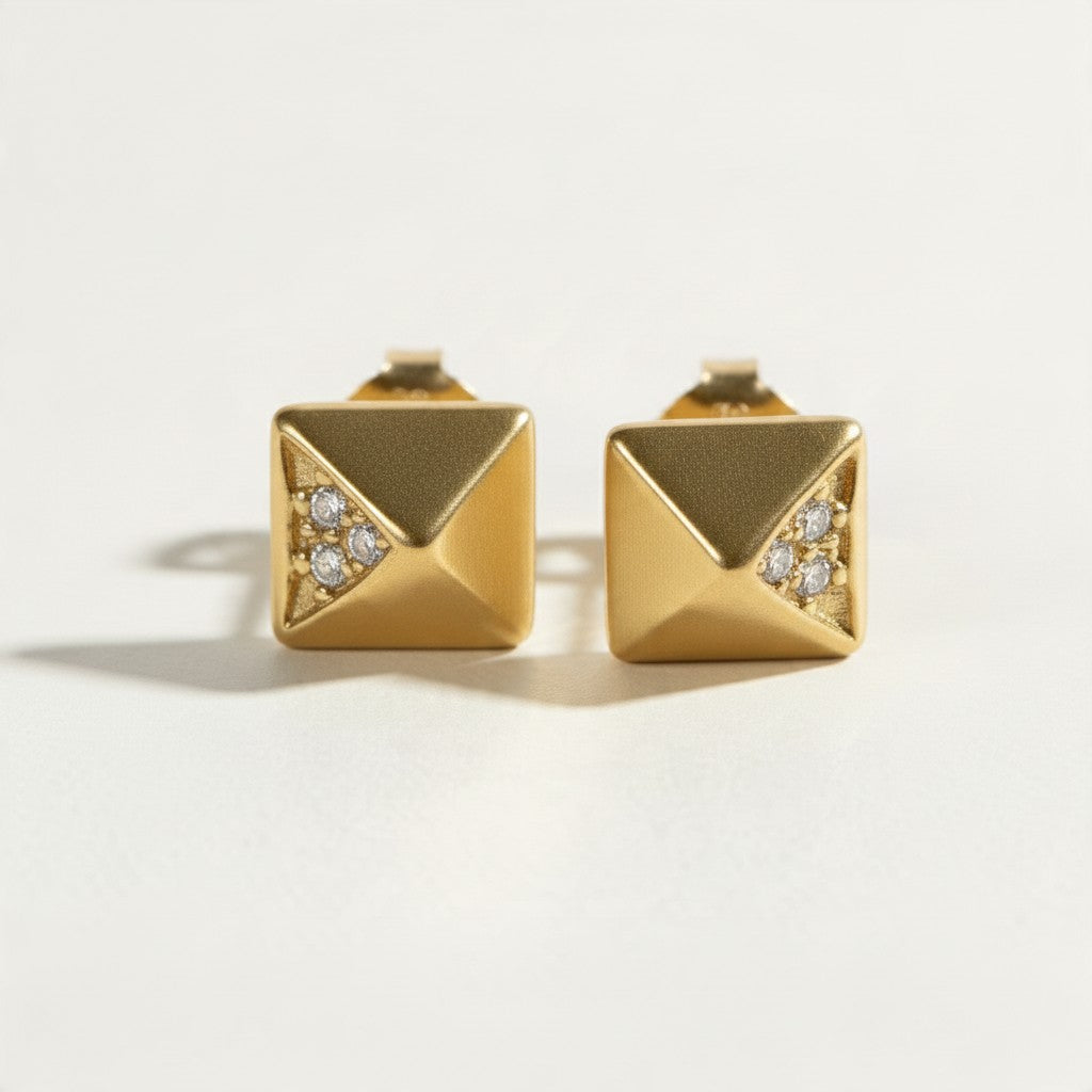 gold pyramid stud earrings, geometric stud earrings, matte gold studs, pyramid earrings with crystals, square stud earrings, minimalist gold studs, modern geometric earrings, cubic zirconia accent studs, edgy gold studs, everyday stud earrings, architectural earrings, women’s gold stud earrings