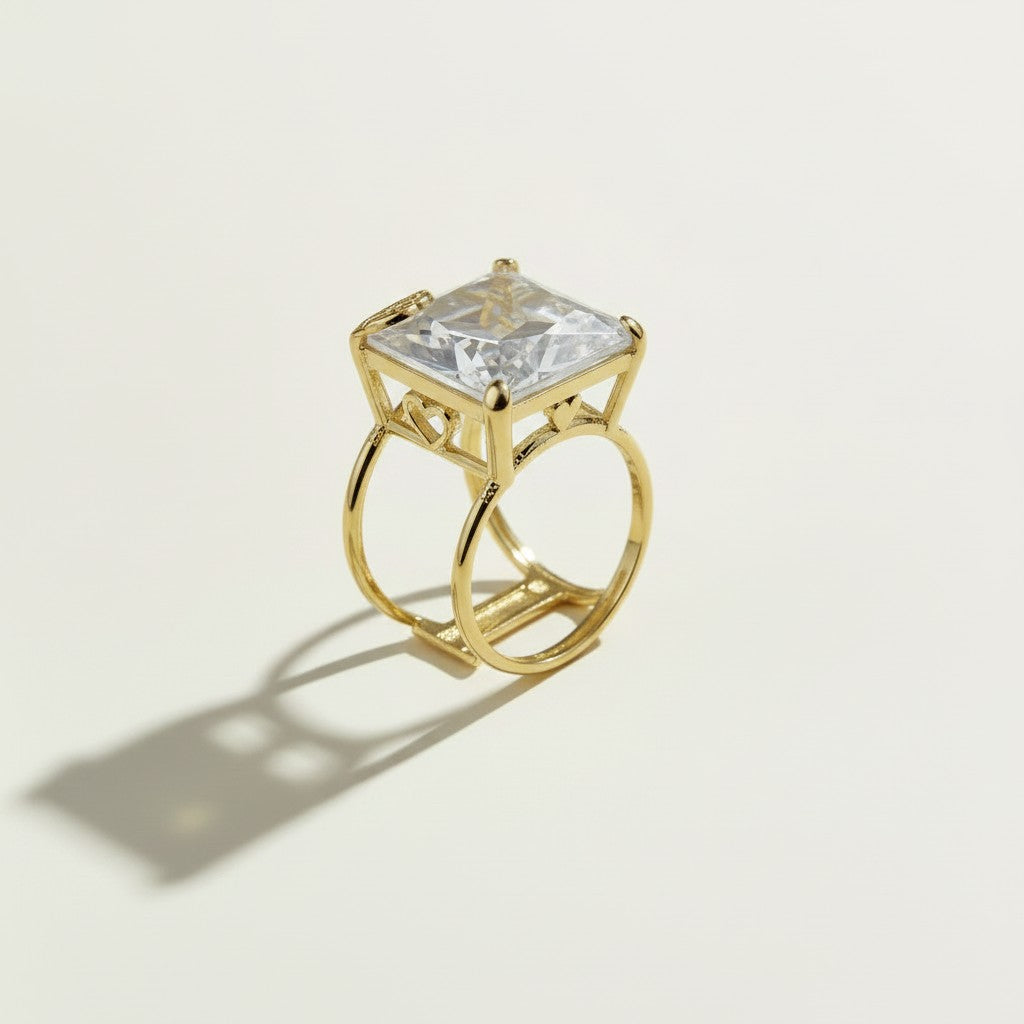 princess cut cocktail ring, double band statement ring, crystal solitaire ring, gold split shank ring, heart detail cocktail ring, oversized crystal ring, statement gold ring