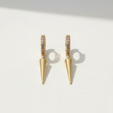 spike drop huggie earrings, pave huggie hoops, gold spike earrings, pink pave earrings, huggie earrings with charm, minimalist spike jewelry, 18K gold overlay earrings, drop earrings flat lay