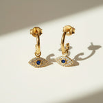 evil eye hoop earrings, gold evil eye charm earrings, 18k gold overlay hoops, pave cubic zirconia earrings, Donna Italiana jewelry, hypoallergenic gold earrings, waterproof gold jewelry, small gold hoop earrings, dainty charm hoops
