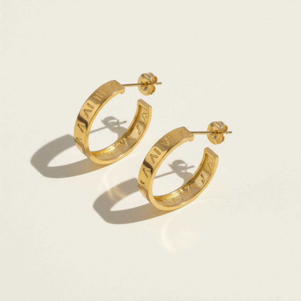 roman numeral hoop earrings, engraved gold hoop earrings, gold hoop earrings flat lay, numeral motif earrings, small gold hoops, post back hoop earrings, everyday gold jewelry, minimalist statement earrings