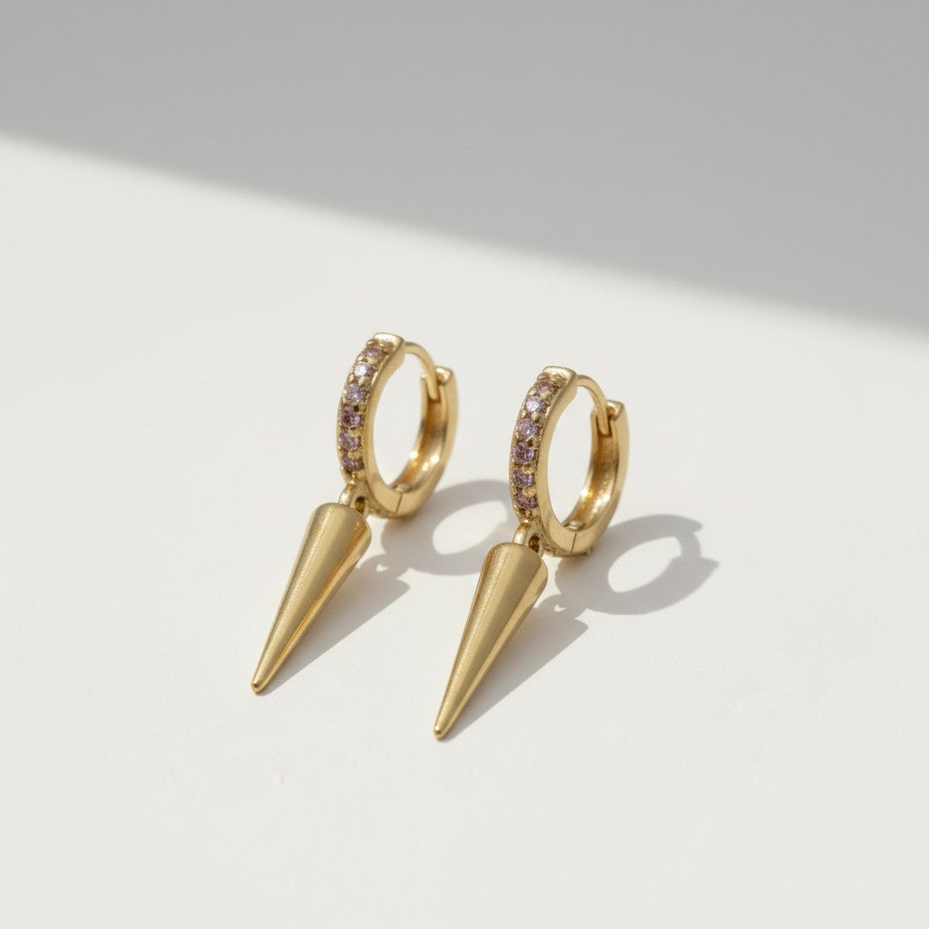 spike drop huggie earrings, pave huggie hoops, gold spike earrings, pink pave earrings, huggie earrings with charm, minimalist spike jewelry, 18K gold overlay earrings, drop earrings flat lay