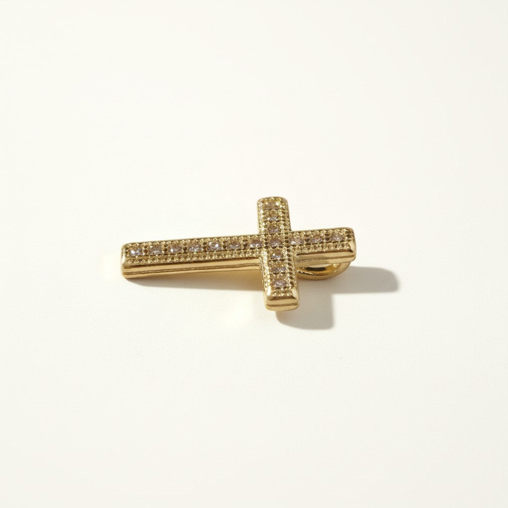 Gold Pavé Cross Pendant Charm, This gold cross pendant charm is fully encrusted in sparkling pavé crystals, with each facet lined in a milgrain-beaded edge for added texture and dimension. The classic cross silhouette offers a timeless, meaningful design suited for religious wear, confirmation and christening gifts, or as an everyday symbolic accent