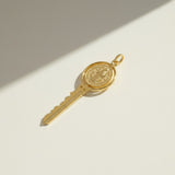 gold key pendant, saint medallion key necklace charm, religious key jewelry, symbolic gold pendant, vintage medal key charm, textured gold pendant, devotional jewelry, novelty key necklace