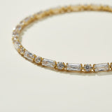 CZ tennis bracelet, baguette round cut bracelet, cubic zirconia tennis bracelet, matching tennis jewelry set, gold tennis bracelet detail, sparkly CZ bracelet flat lay, prong set CZ bracelet, tennis bracelet clasp detail