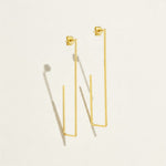 gold rectangle earrings, long geometric earrings, minimalist gold wire earrings, open rectangle hoop earrings, modern gold drop earrings, lightweight statement earrings, architectural earrings, thin gold wire earrings, elongated hoop earrings, contemporary gold jewelry, linear gold earrings, women’s geometric earrings