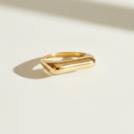 vertical bar ring flat lay, gold bar ring detail, minimalist geometric ring, modern stacking ring, architectural gold ring, sleek bar ring, curved band ring, statement bar ring