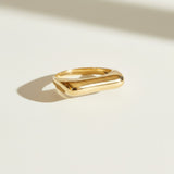 vertical bar ring flat lay, gold bar ring detail, minimalist geometric ring, modern stacking ring, architectural gold ring, sleek bar ring, curved band ring, statement bar ring