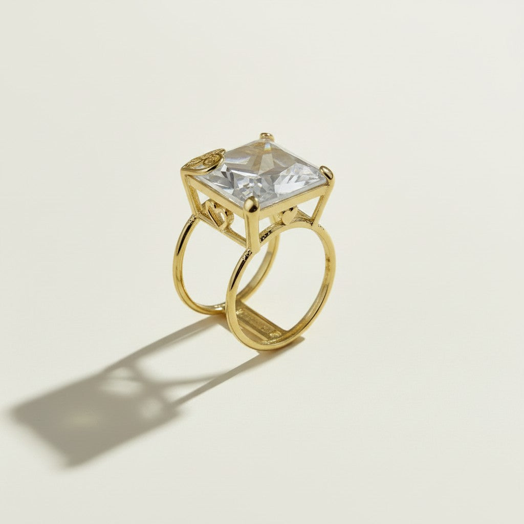 princess cut cocktail ring, double band statement ring, crystal solitaire ring, gold split shank ring, heart detail cocktail ring, oversized crystal ring, statement gold ring