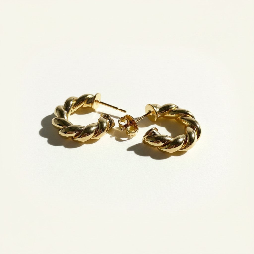 twisted rope hoop earrings flat lay, gold rope texture hoops detail, small twisted hoops, textured gold hoop earrings, everyday gold hoops, sculptural rope earrings, statement gold hoops, polished twisted earrings