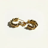twisted rope hoop earrings flat lay, gold rope texture hoops detail, small twisted hoops, textured gold hoop earrings, everyday gold hoops, sculptural rope earrings, statement gold hoops, polished twisted earrings