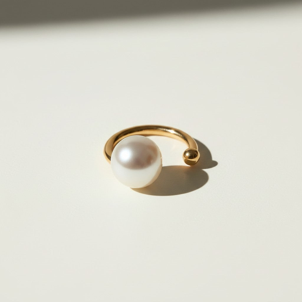 pearl ear cuff, gold ear cuff with pearl, sculptural ear cuff, asymmetric ear cuff, avant-garde pearl jewelry, no-piercing ear cuff, modern pearl earring, artistic gold ear cuff