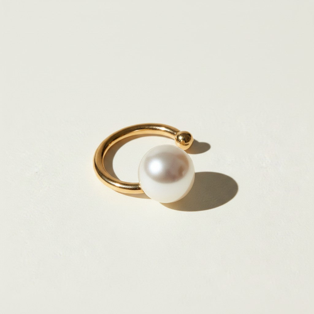 pearl ear cuff, gold ear cuff with pearl, sculptural ear cuff, asymmetric ear cuff, avant-garde pearl jewelry, no-piercing ear cuff, modern pearl earring, artistic gold ear cuff
