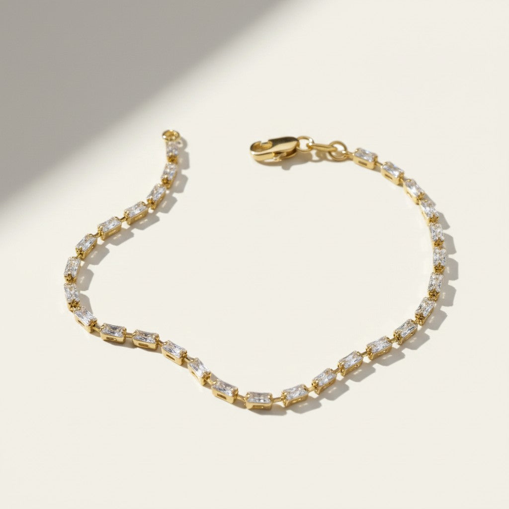 baguette CZ tennis bracelet, all baguette cubic zirconia bracelet, gold baguette bracelet flat lay, art deco tennis bracelet, sparkly baguette bracelet, emerald cut CZ bracelet, tennis bracelet clasp detail, uniform stone tennis bracelet