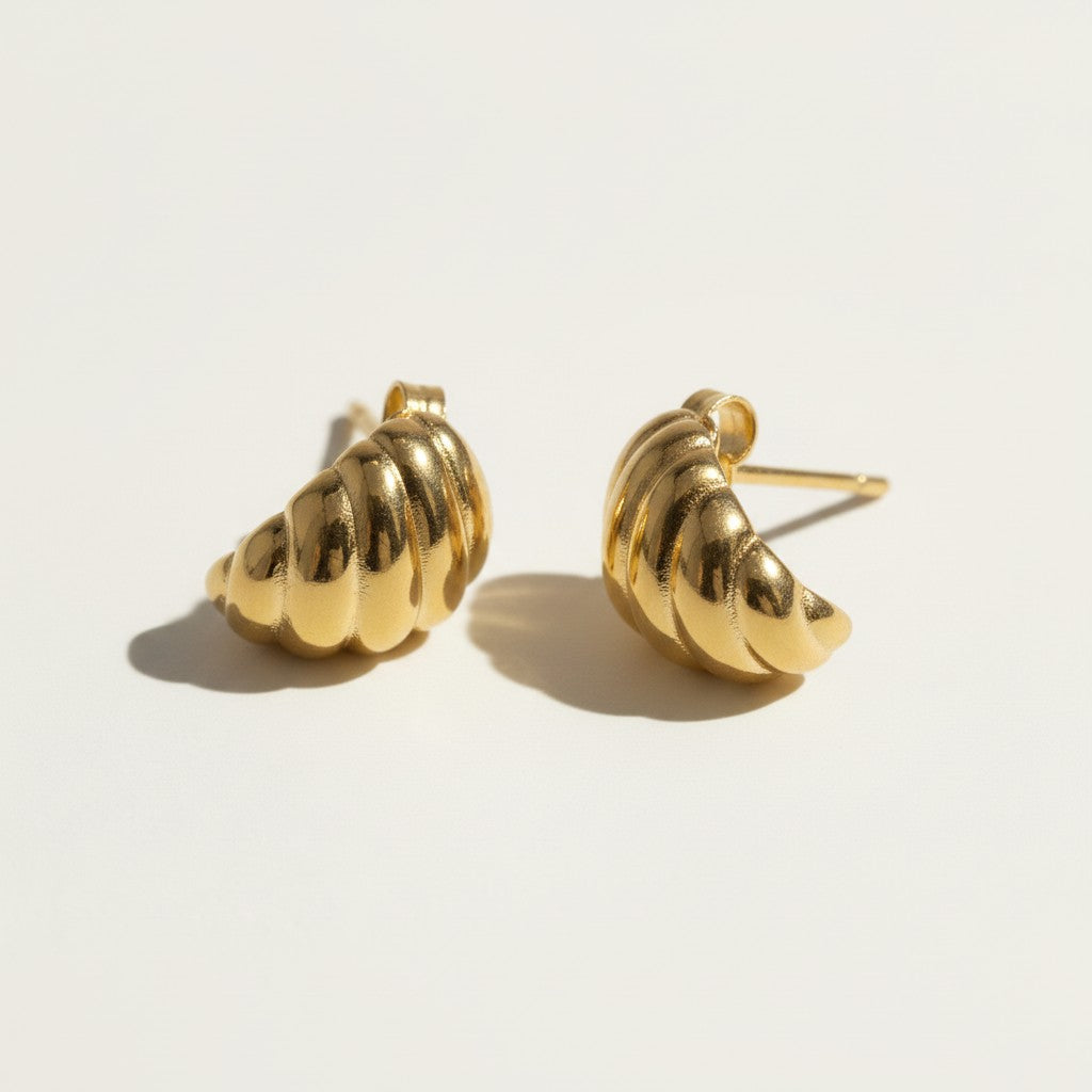 ribbed gold hoop earrings flat lay, fluted gold dome earrings detail, croissant hoop earrings, sculptural ribbed earrings, high polish gold hoops, textured gold stud earrings, retro gold earrings, gold dome earring construction
