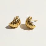 ribbed gold hoop earrings flat lay, fluted gold dome earrings detail, croissant hoop earrings, sculptural ribbed earrings, high polish gold hoops, textured gold stud earrings, retro gold earrings, gold dome earring construction