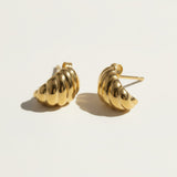 ribbed gold hoop earrings flat lay, fluted gold dome earrings detail, croissant hoop earrings, sculptural ribbed earrings, high polish gold hoops, textured gold stud earrings, retro gold earrings, gold dome earring construction