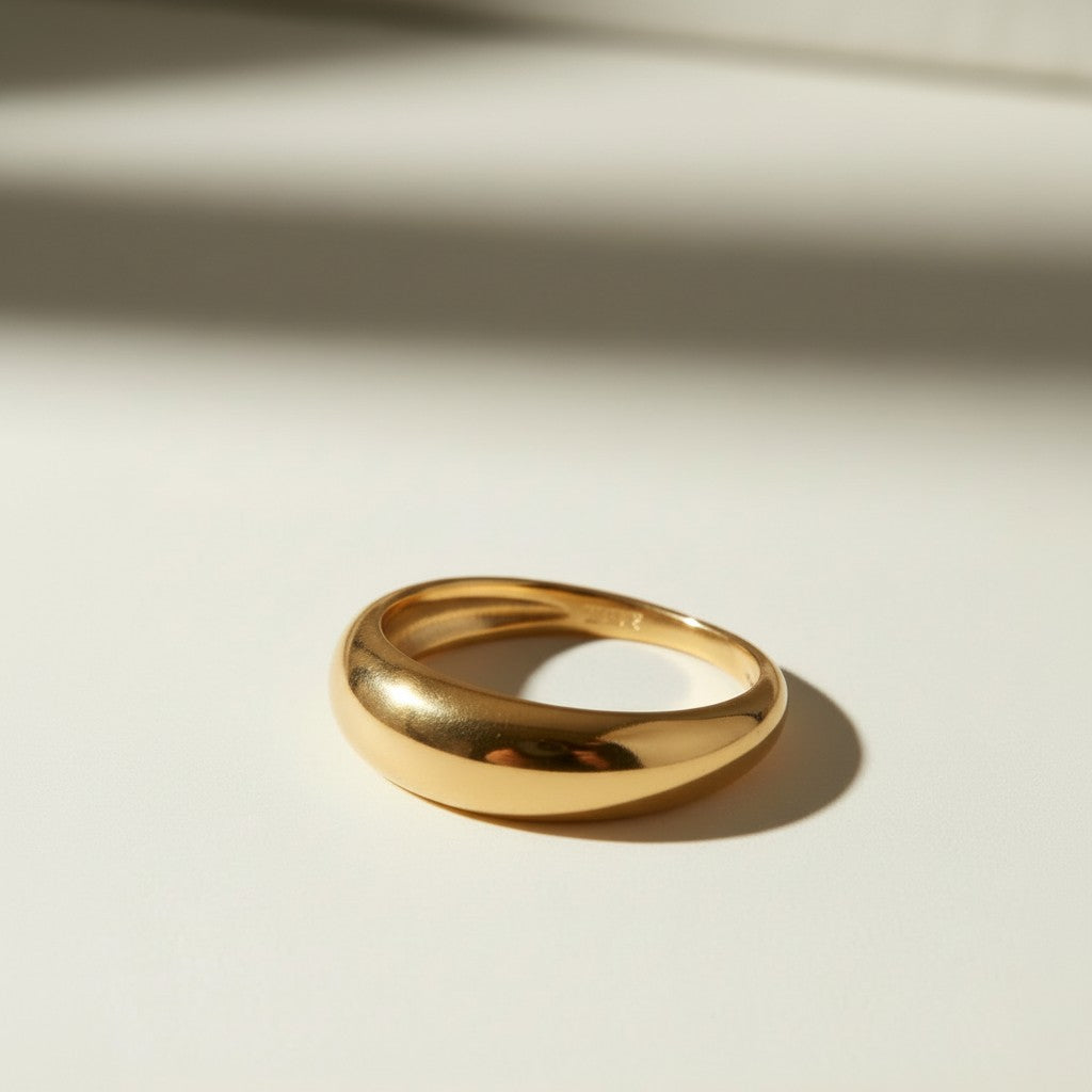 chunky dome ring flat lay, gold dome ring detail, bold gold band ring, teardrop dome ring, 18k gold overlay ring, thick gold ring, statement gold ring, smooth gold band ring