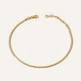 herringbone chain anklet flat lay, gold anklet construction detail, 18k gold overlay anklet, adjustable gold ankle chain, herringbone anklet clasp, matching jewelry set anklet, flat link ankle chain, gold anklet macro detail