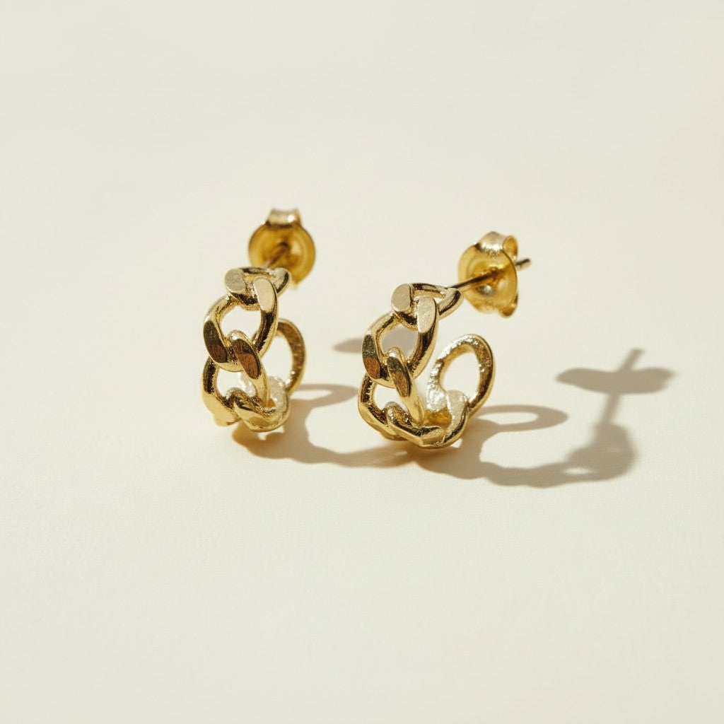 textured chain-link hoop earrings flat lay, gold chain hoop earrings detail, chunky textured hoops, small gold hoops, sculptural gold hoops, statement chain earrings, everyday textured hoops, gold link earrings