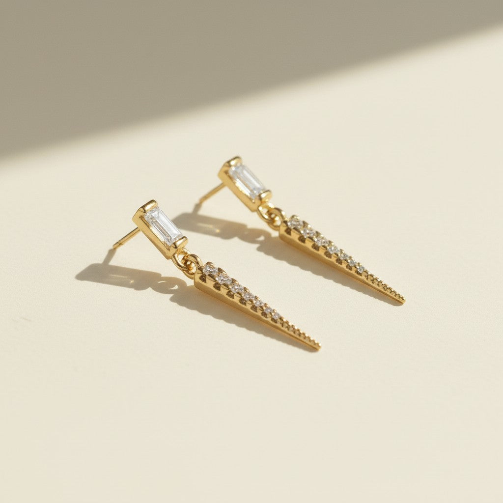 baguette crystal earrings, crystal drop earrings detail, pave spike earrings, gold drop earrings, 18K gold overlay earrings, dainty crystal drop, statement stud earrings, crystal earrings flat lay