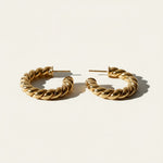 twisted rope hoop earrings flat lay, gold rope texture hoops detail, small twisted hoops, textured gold hoop earrings, everyday gold hoops, sculptural rope earrings, statement gold hoops, polished twisted earrings