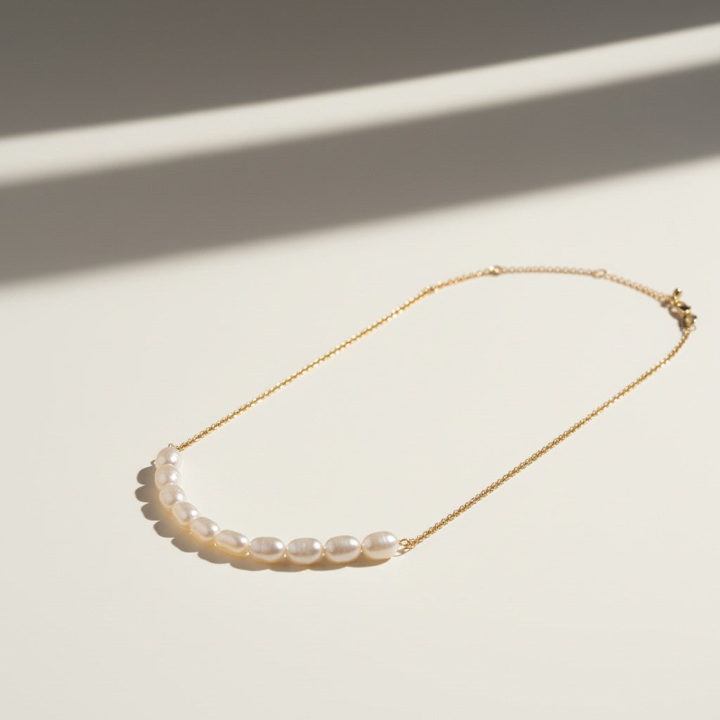 gold pearl cluster necklace, freshwater pearl bar necklace, clustered pearl necklace, modern pearl necklace, gold chain pearl necklace, asymmetric pearl necklace, dainty pearl cluster jewelry, pearl necklace flat lay