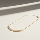 gold pearl cluster necklace, freshwater pearl bar necklace, clustered pearl necklace, modern pearl necklace, gold chain pearl necklace, asymmetric pearl necklace, dainty pearl cluster jewelry, pearl necklace flat lay