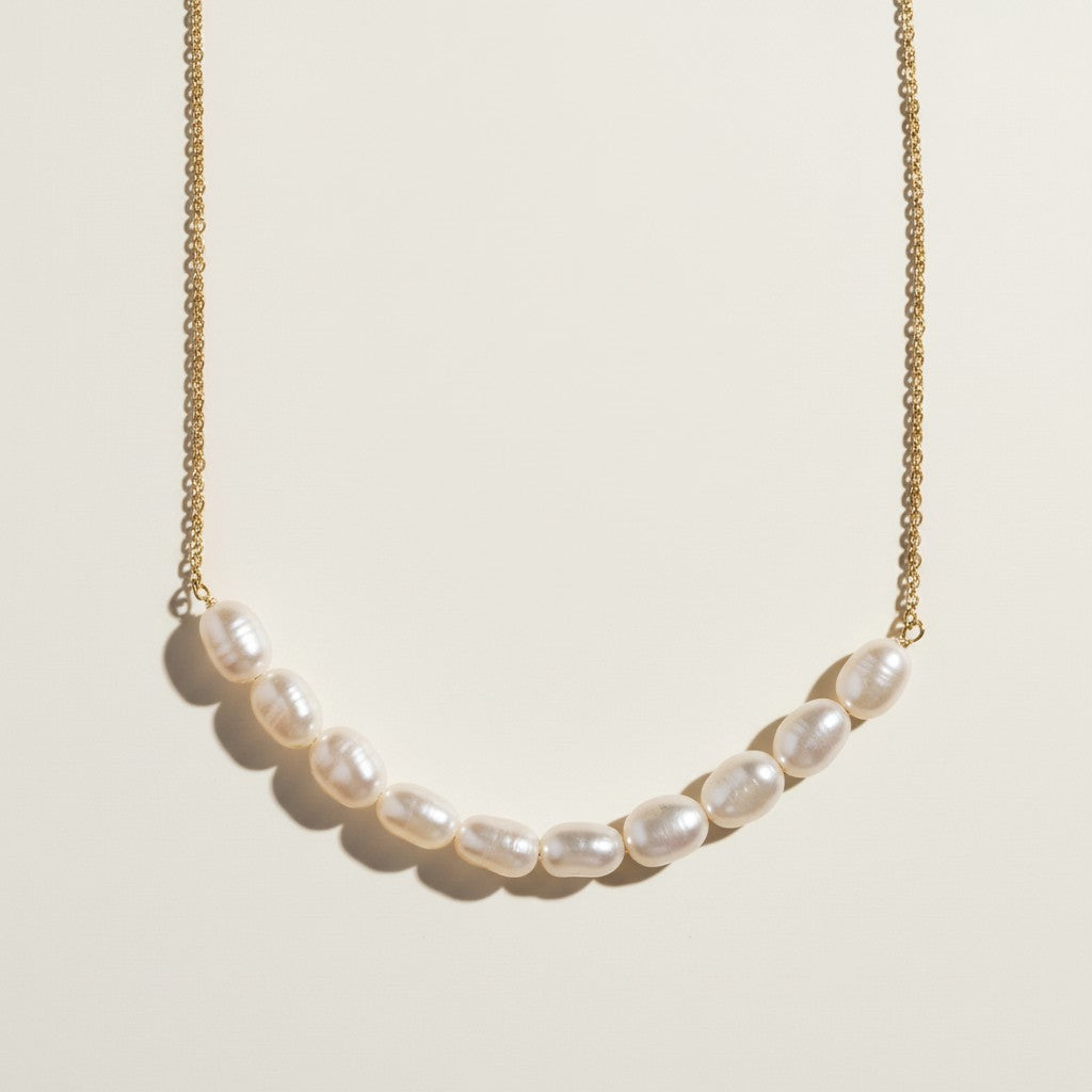 gold pearl cluster necklace, freshwater pearl bar necklace, clustered pearl necklace, modern pearl necklace, gold chain pearl necklace, asymmetric pearl necklace, dainty pearl cluster jewelry, pearl necklace flat lay
