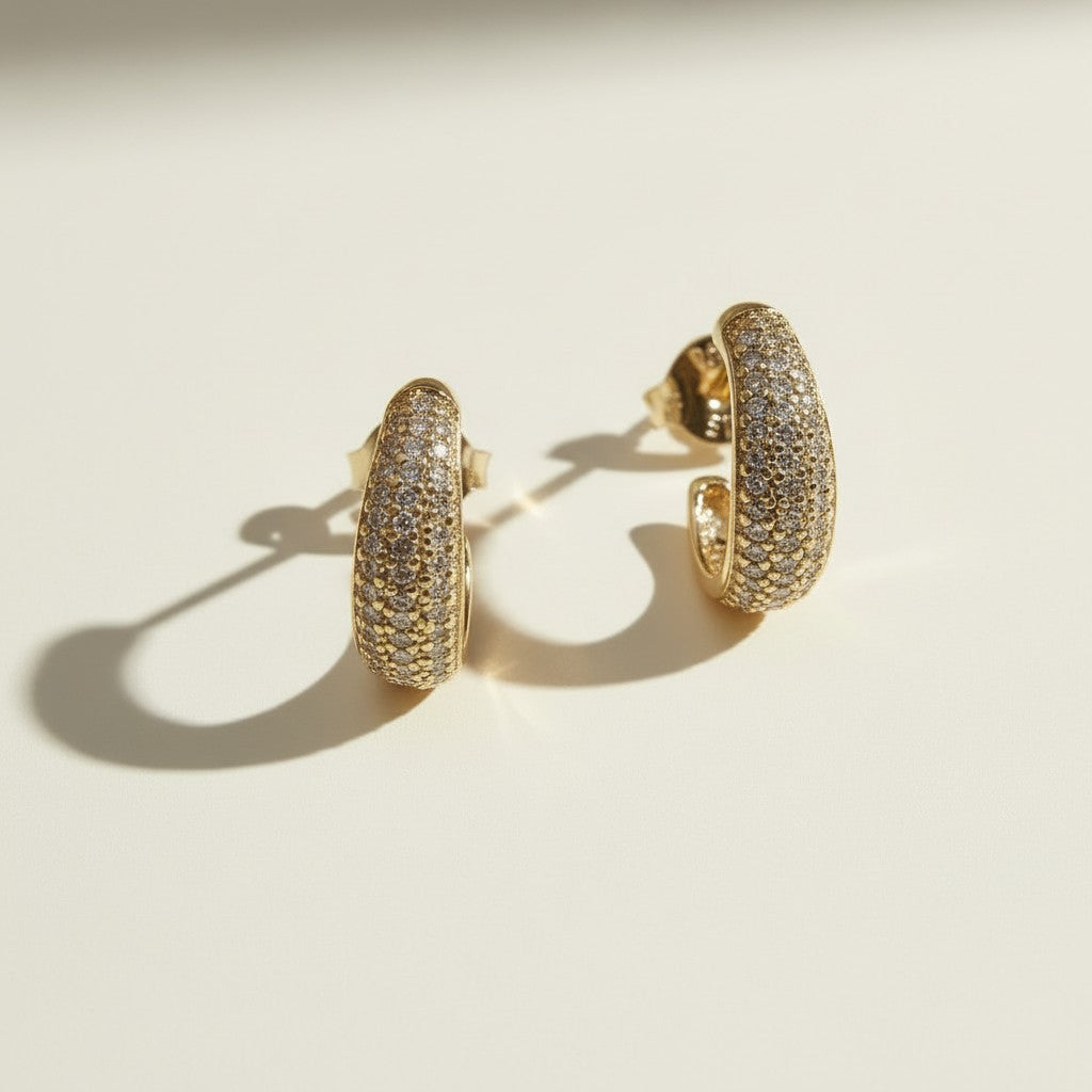 textured gold hoop earrings flat lay, pave dome hoop earrings, sparkly textured hoops detail, micro CZ gold hoops, stardust texture earrings, tapered gold huggie hoops, sugared gold earrings, statement pave hoops