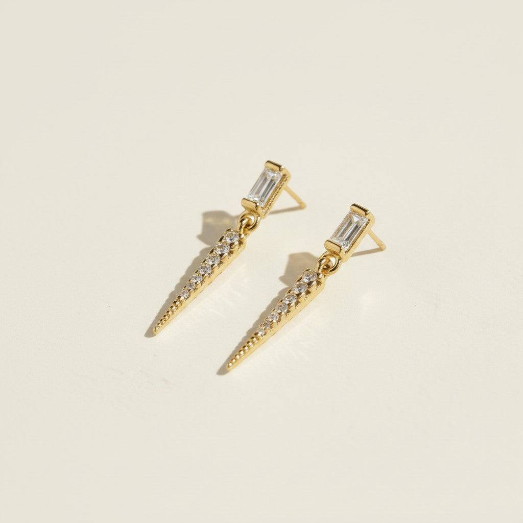 baguette crystal earrings, crystal drop earrings detail, pave spike earrings, gold drop earrings, 18K gold overlay earrings, dainty crystal drop, statement stud earrings, crystal earrings flat lay