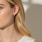 bezel set huggie hoops, crystal huggie earrings on-model, chunky gold hoop earrings, cubic zirconia hoop earrings, 18K gold overlay huggies, statement huggie hoops, bezel stone earrings, gold hoops close-up