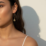 gold coin charm earrings, coin hoop earrings, gold hoop earrings with charm, vintage coin jewelry, dangle hoop earrings, everyday gold earrings, medallion earrings, on-model earring photography