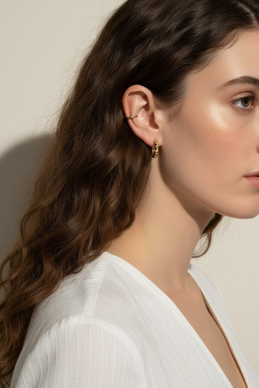 gold pyramid hoops on model, layered ear stack, textured huggie hoop earrings, simple gold ear cuff, gold hoop and cuff set, ear stacking gold jewelry, minimalist ear cuff pairing, edgy gold hoops worn