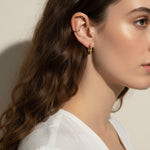 gold pyramid hoops on model, layered ear stack, textured huggie hoop earrings, simple gold ear cuff, gold hoop and cuff set, ear stacking gold jewelry, minimalist ear cuff pairing, edgy gold hoops worn