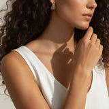 gold beaded hoop earrings on model, cluster hoop earrings worn, textured gold hoops styled, tiered gold earrings on ear, statement beaded earrings lifestyle, chunky gold hoops worn, sculptural gold earrings on model