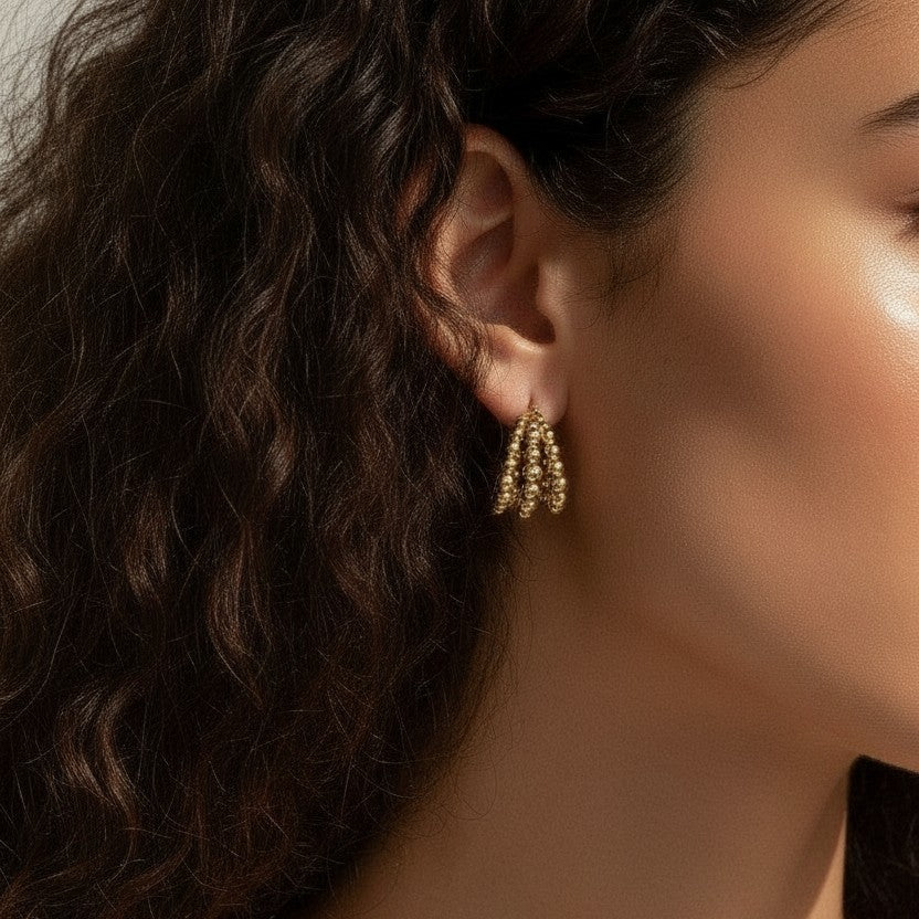 gold beaded hoop earrings on model, cluster hoop earrings worn, textured gold hoops styled, tiered gold earrings on ear, statement beaded earrings lifestyle, chunky gold hoops worn, sculptural gold earrings on model
