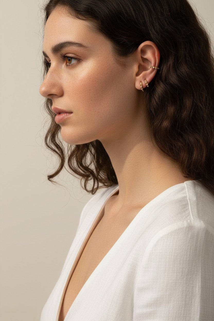 gold beaded huggie hoops, small gold hoop earrings, stacked ear look, beaded hoop earrings, layered earring set, gold huggie hoops on model, dainty gold hoops, curated ear stack