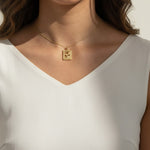 tulip pendant necklace on model, gold flower tag necklace lifestyle, botanical pendant necklace worn, engraved tulip necklace styled, dainty gold necklace on neck, CZ accent pendant, nature-inspired jewelry, rope-edge tag necklace