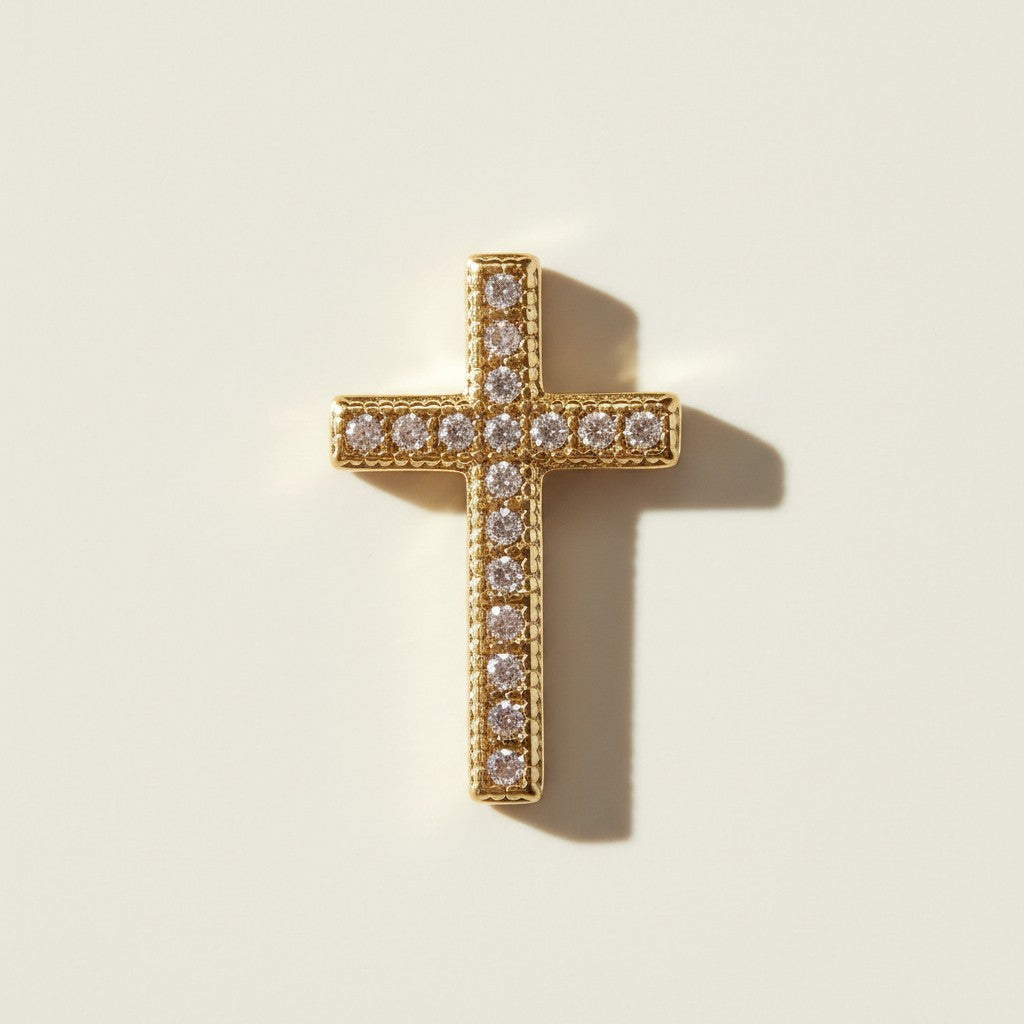 Gold Pavé Cross Pendant Charm, This gold cross pendant charm is fully encrusted in sparkling pavé crystals, with each facet lined in a milgrain-beaded edge for added texture and dimension. The classic cross silhouette offers a timeless, meaningful design suited for religious wear, confirmation and christening gifts, or as an everyday symbolic accent