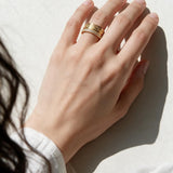 Greek key ring on model, wide gold band ring on hand, meander pattern ring, pavé band ring lifestyle, engraved gold statement ring, geometric gold band styled